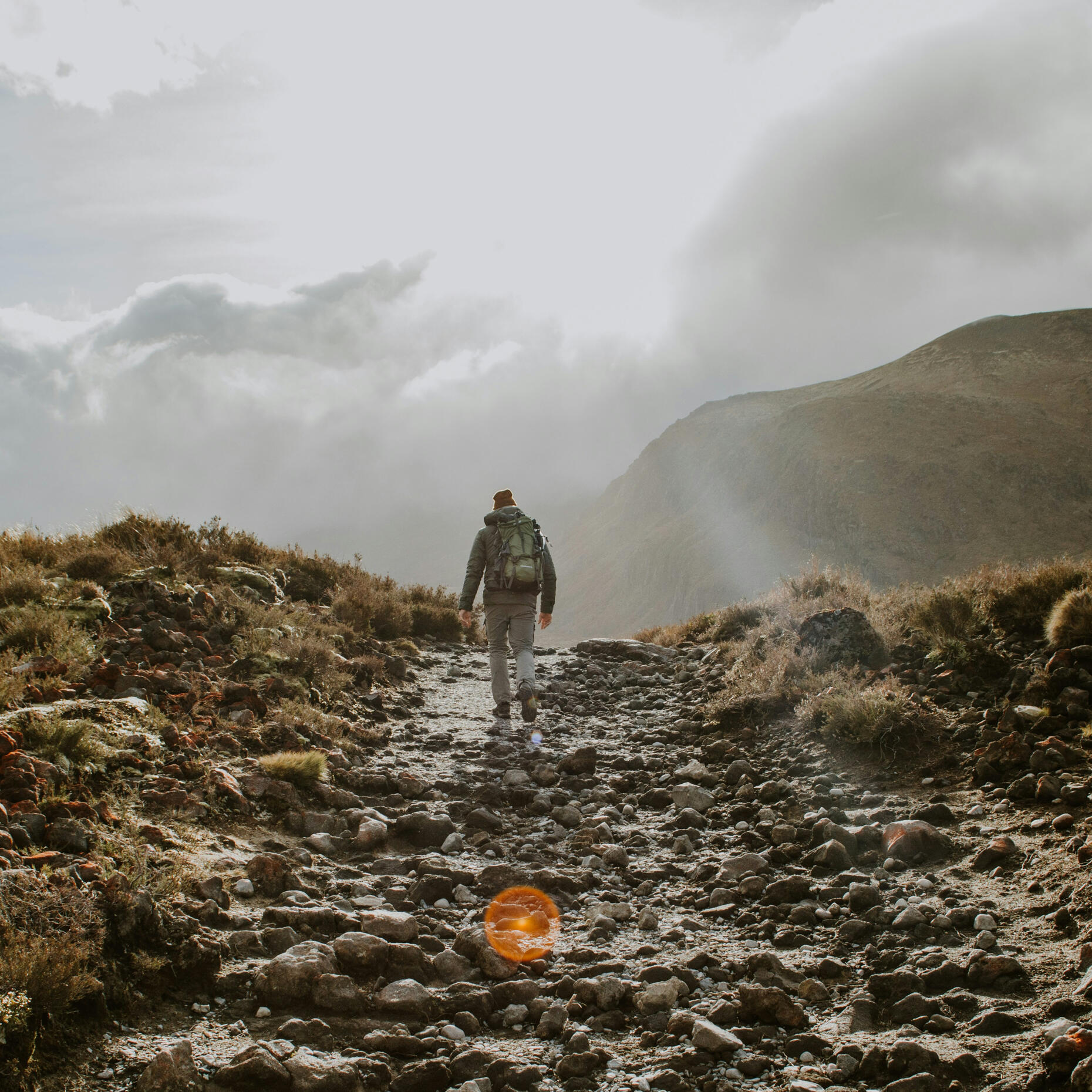 Moving forward on your personal pathway Man walking along a pathway towards a mountain, representing personal growth, direction and progress through coaching