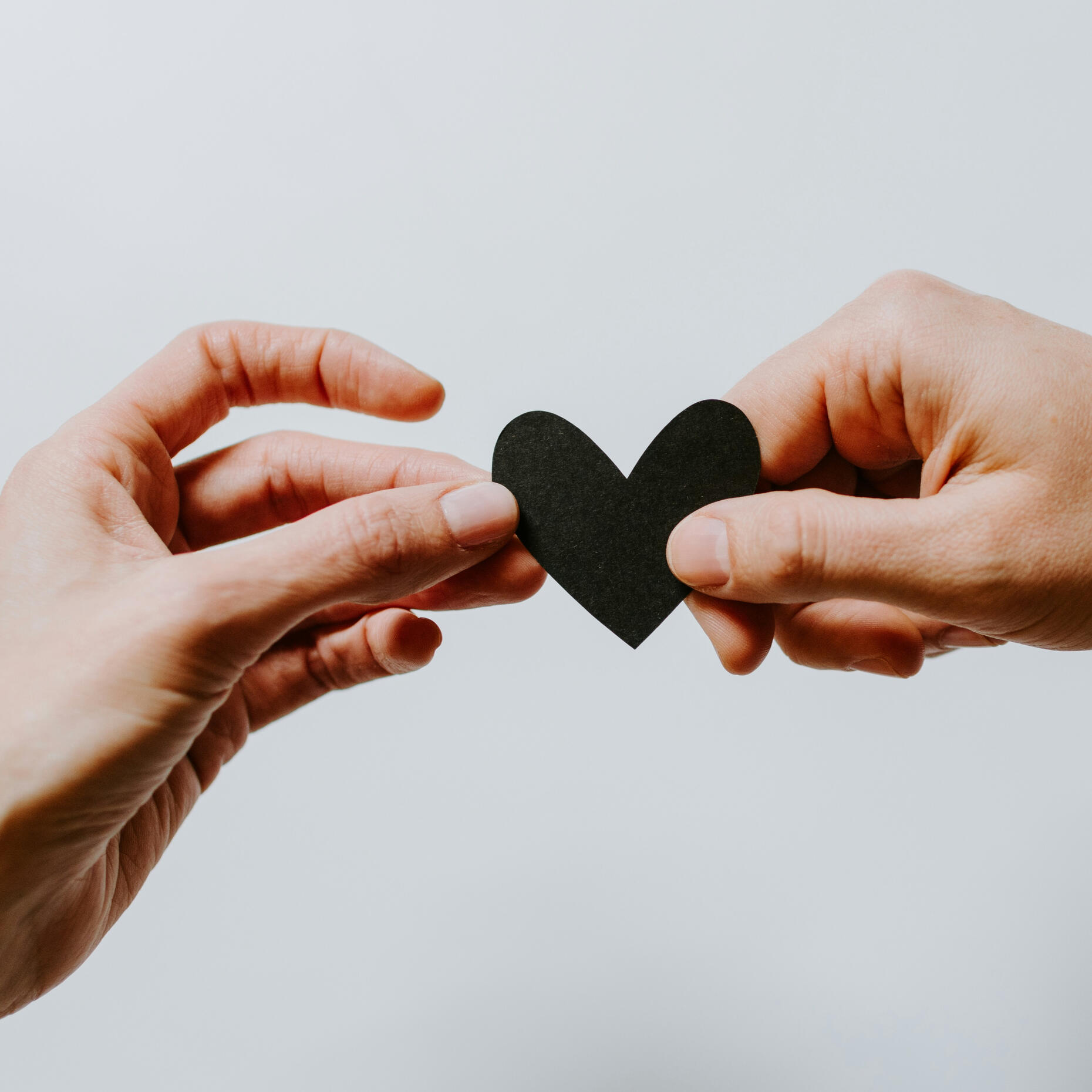 Compassion and support for those who care for others Two hands holding a heart shape, representing compassion, care and support for helping professionals